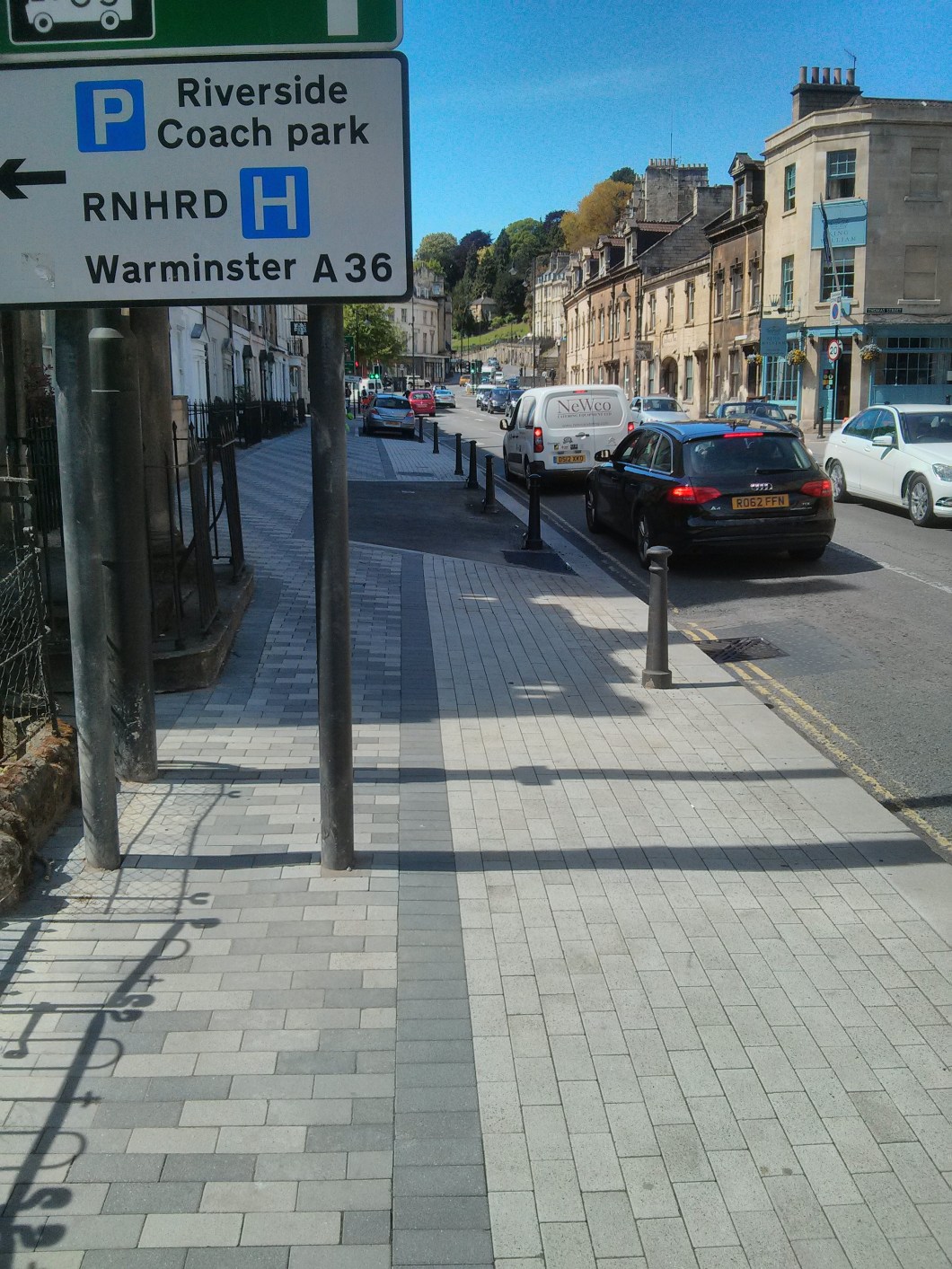 Pedestrian path blocked by road sign so pedestrians forced into cycle track.