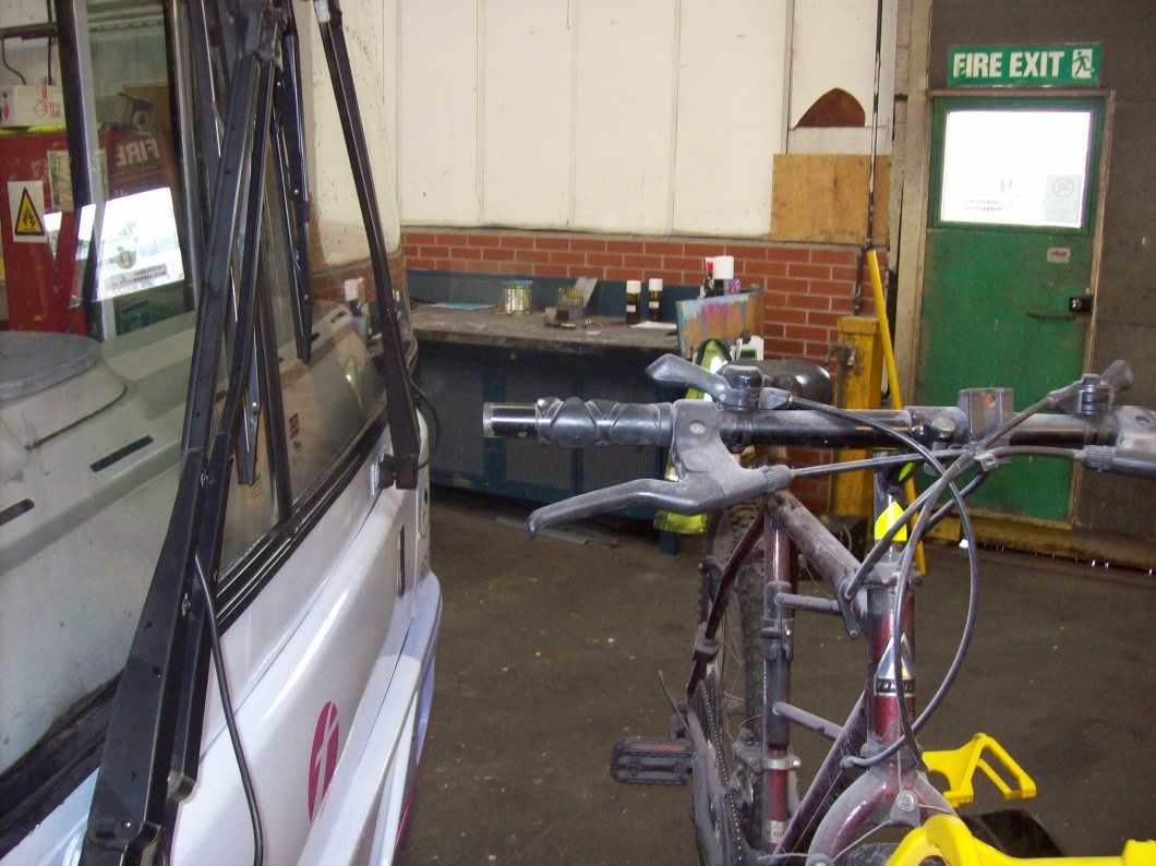 Cycle rack with one bike in place. Note distance of handlebar from glass.